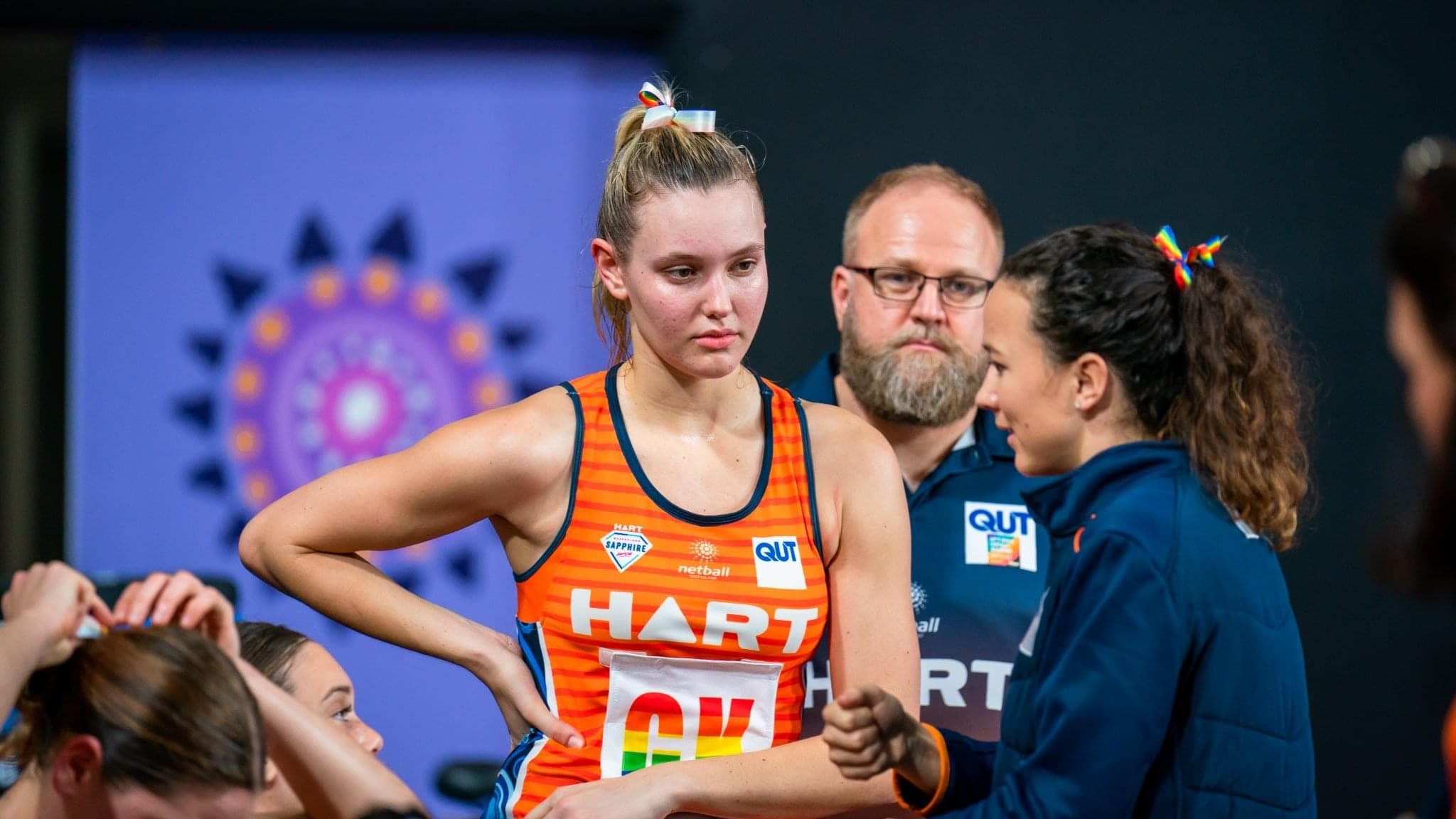 Caitlyn Strachan in coaching colours giving live instruction to a young Goal Keeper during a HART Sapphire Series match.